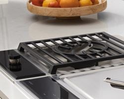 Wolf 15" transitional gas cooktop module (CG152TFS) paired with a 15" transitional teppanyaki module (TM15TFS) and 15" transitional multifunction module (MM15TFS)